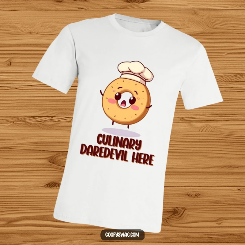 Funny t-shirt with a surprised bagel wearing a chef hat, comically attempting to flip itself, showcasing kitchen chaos.