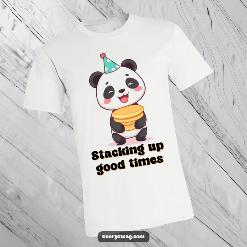 Funny beaming panda wearing a party hat, comically balancing pancakes, a hilarious and festive t-shirt graphic.