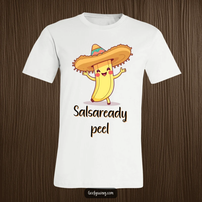 Funny T-shirt depicting a banana peel wearing a festive sombrero and performing a lively cha-cha dance, radiating pure joy.